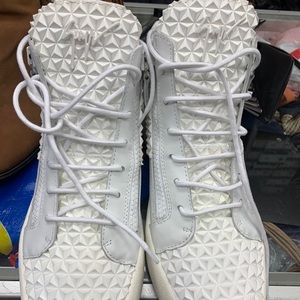 All white high top Giuseppe sneakers.
